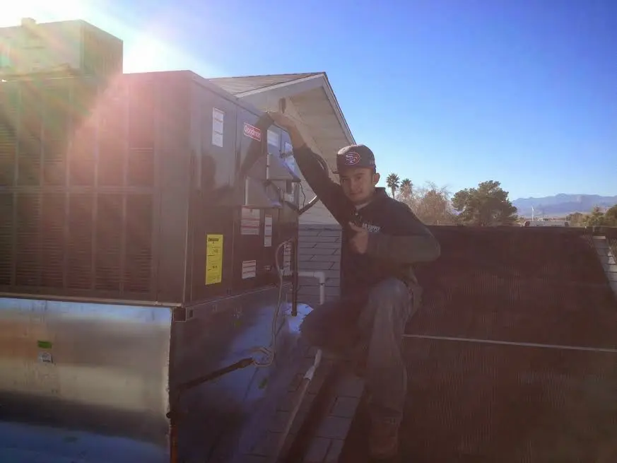 HVAC technician performing AC Tune-Up on a rooftop unit in Evanston